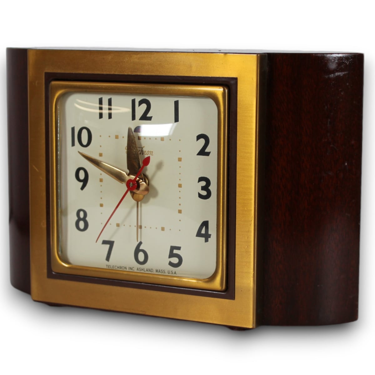 Archived catalog photograph of a rectangular Telechron clock with a dark wood-toned case, brass-toned face surround, and cream square dial