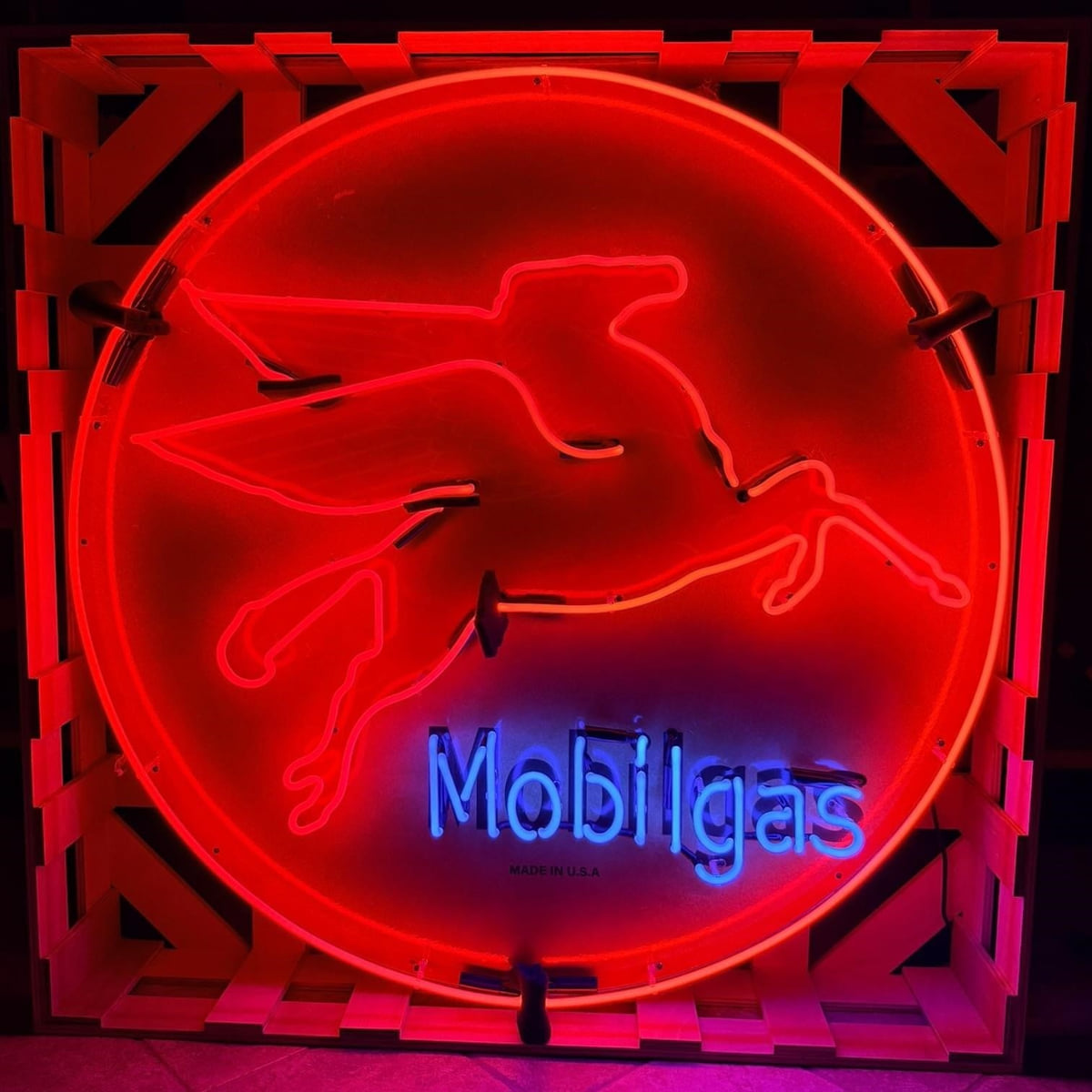Actual catalog photograph of an illuminated round Mobilgas advertising display with a red Pegasus outline and blue Mobilgas lettering