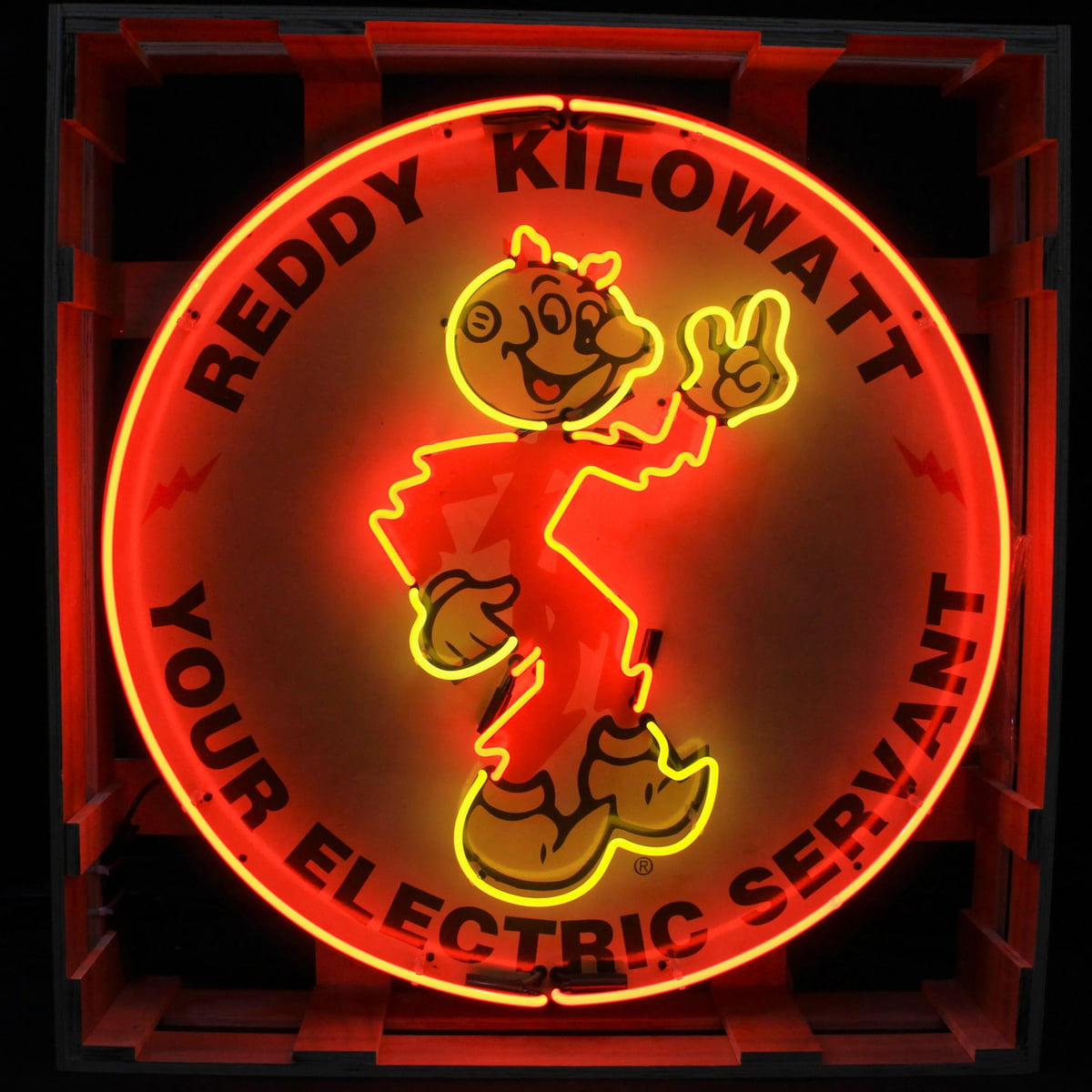 Actual catalog photograph of an illuminated round Reddy Kilowatt Your Electric Servant display with a red border and yellow character outline