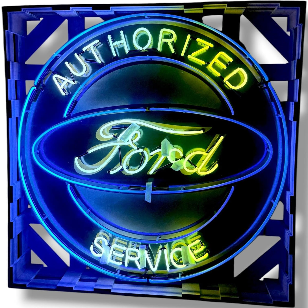 Actual catalog photograph of an illuminated Ford Authorized Service advertising display with a blue oval and blue, green, and white neon