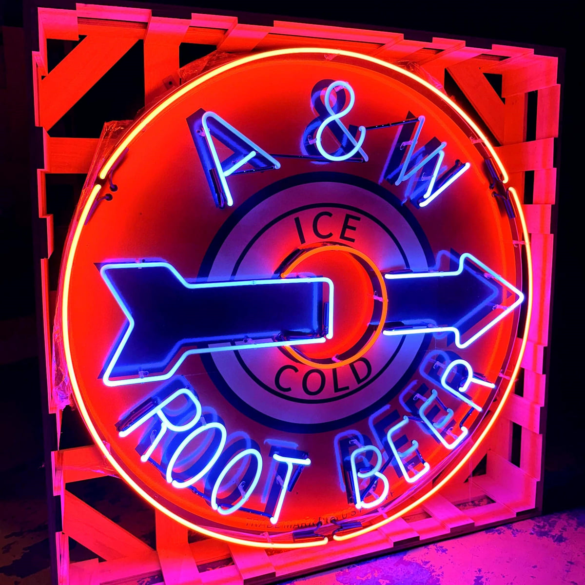 Actual catalog photograph of an illuminated round A&W Ice Cold Root Beer display in red, blue, and white neon