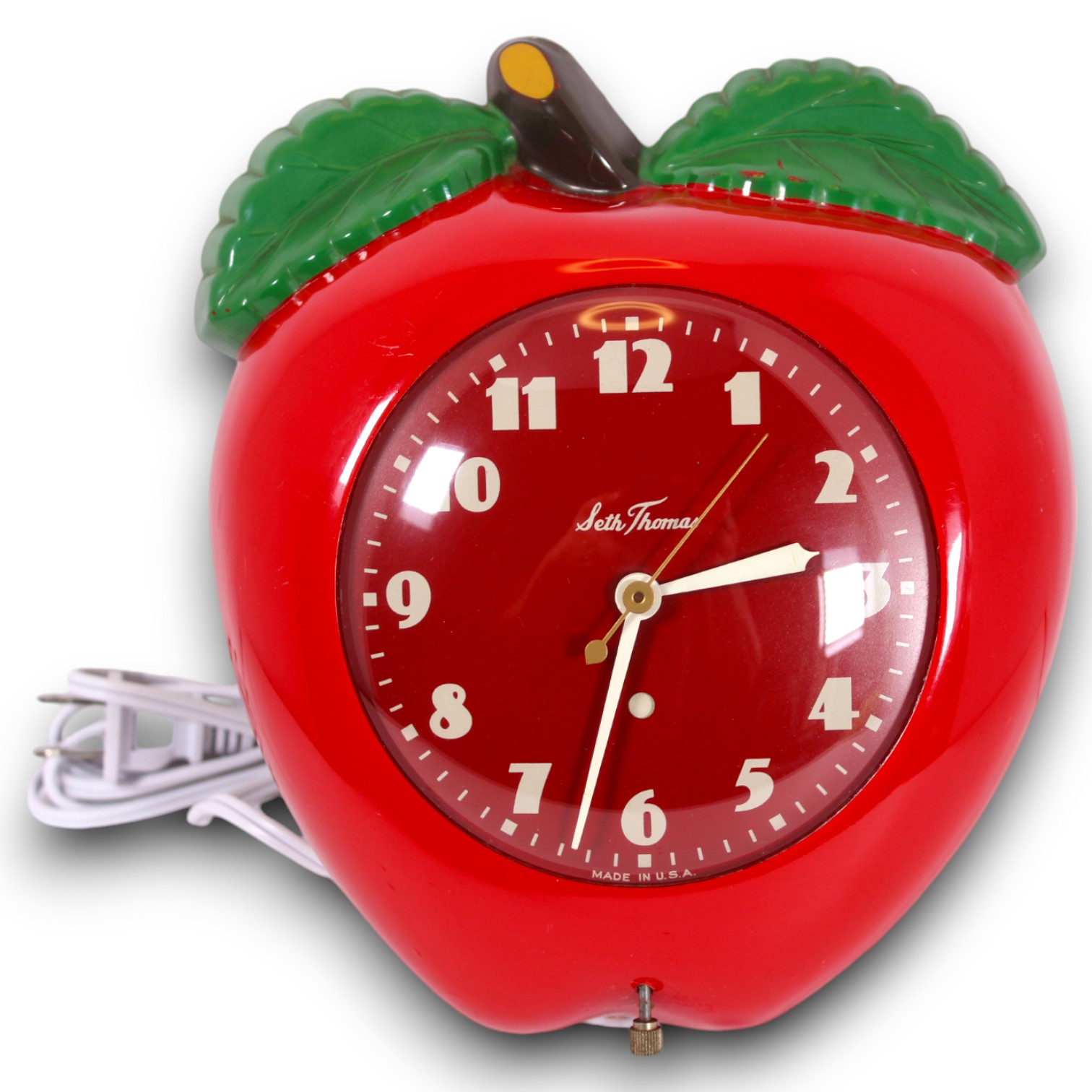 Catalog photograph of a red apple-shaped Seth Thomas tabletop clock