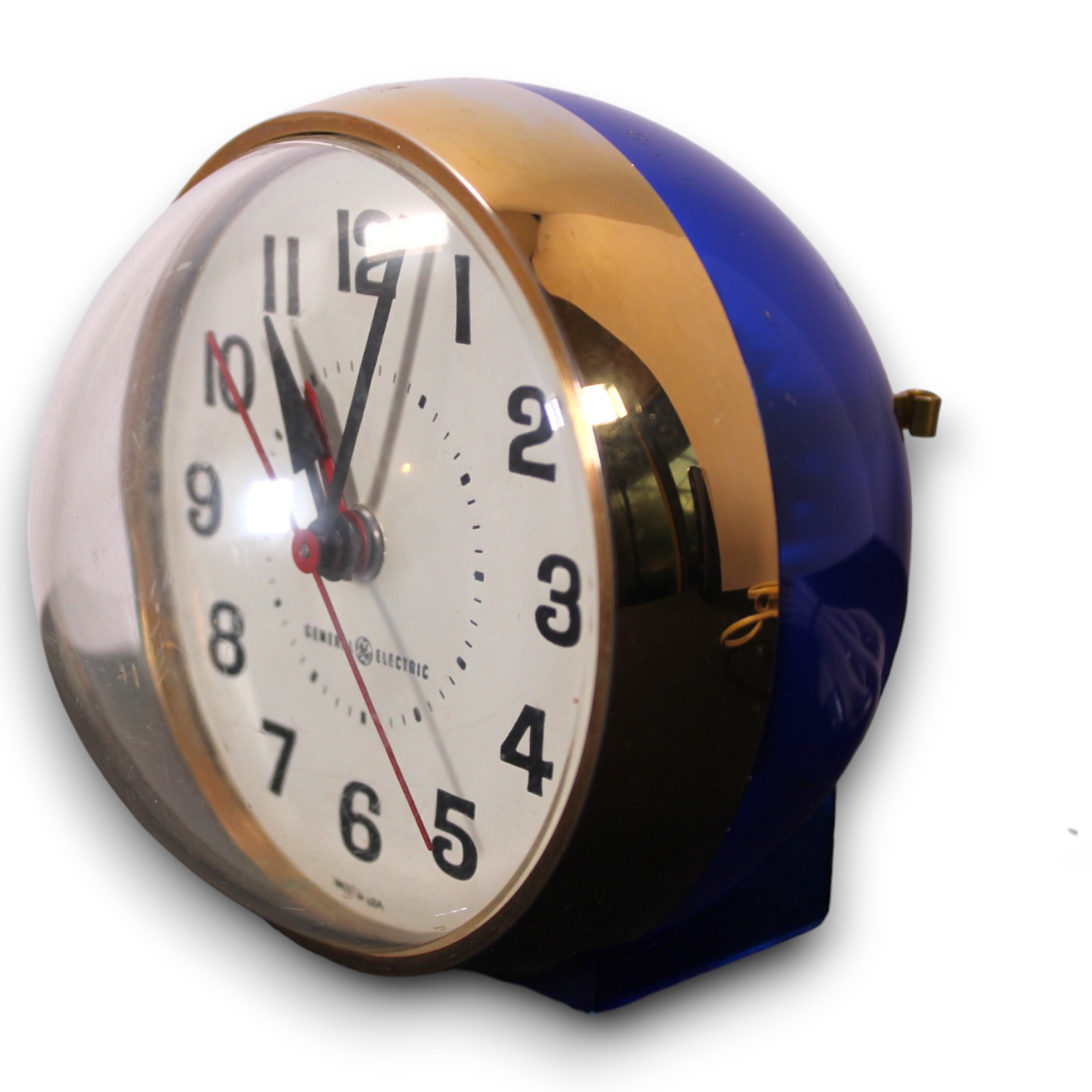 Blue and brass General Electric sphere alarm clock photographed on white