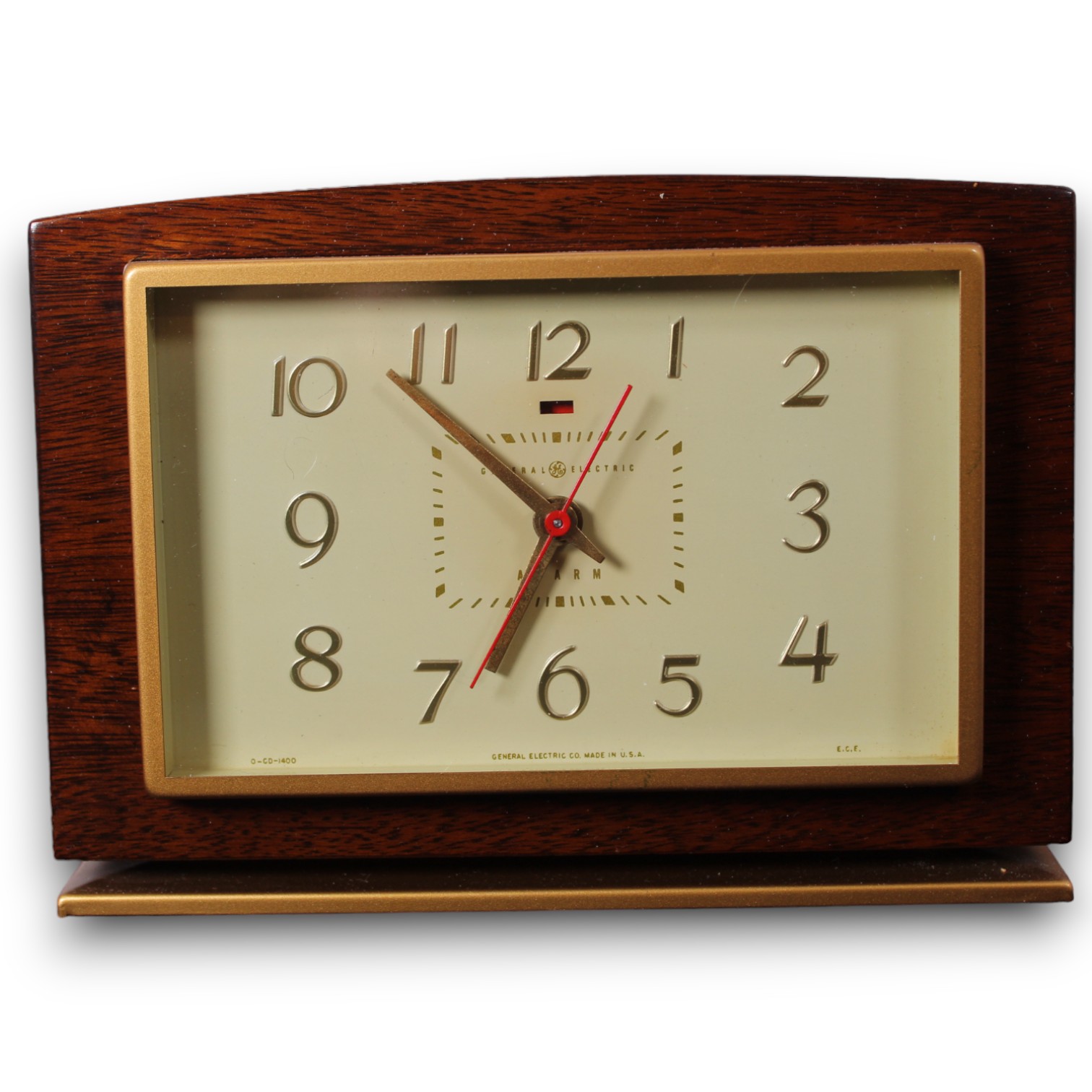 Catalog photograph of a traditional tabletop clock with a wood-toned case and brass-toned details