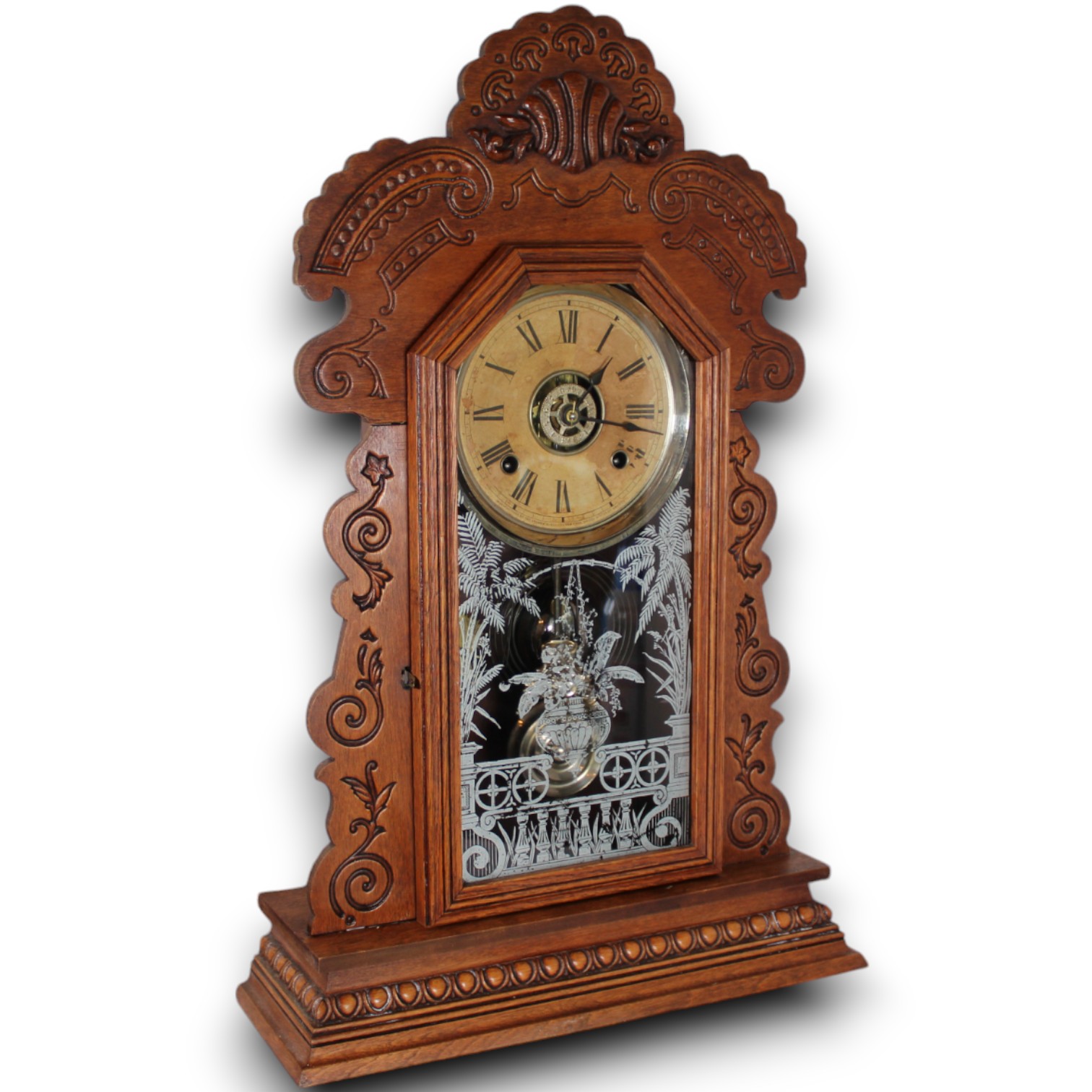 Carved wooden clock with an etched-glass door photographed on white